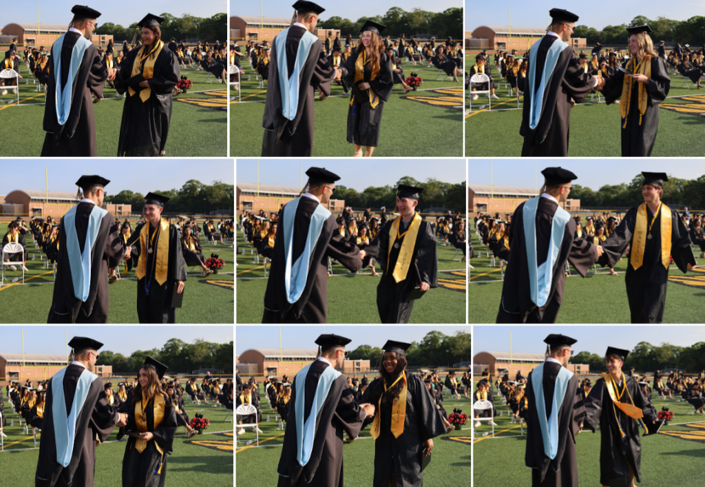 students receiving diplomas and shaking mans hand